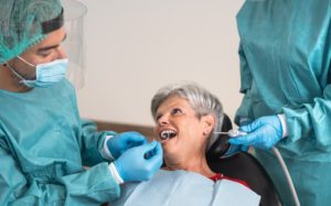 man-dentist-operating-senior-woman-in-dental-clini-2021-07-06-18-14-59-utc (1)